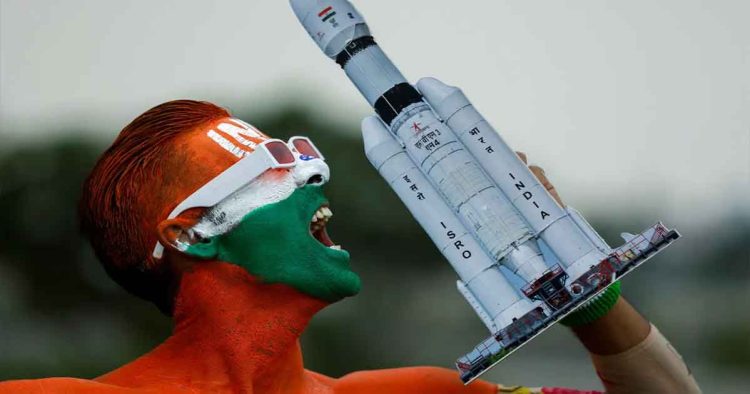 Arun Haryani holds up a model of LVM3-M4, which was used in launching of Chandrayaan-3 spacecraft, on the eve of its moon landing, in Ahmedabad, India. [Amit Dave/Reuters]